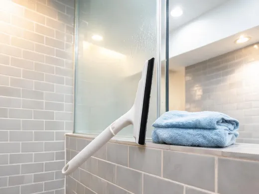 Bathroom glass and tile cleaning with squeegee